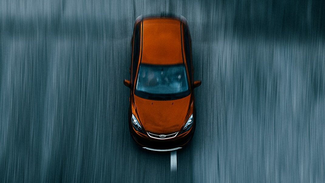 orange and black car on water