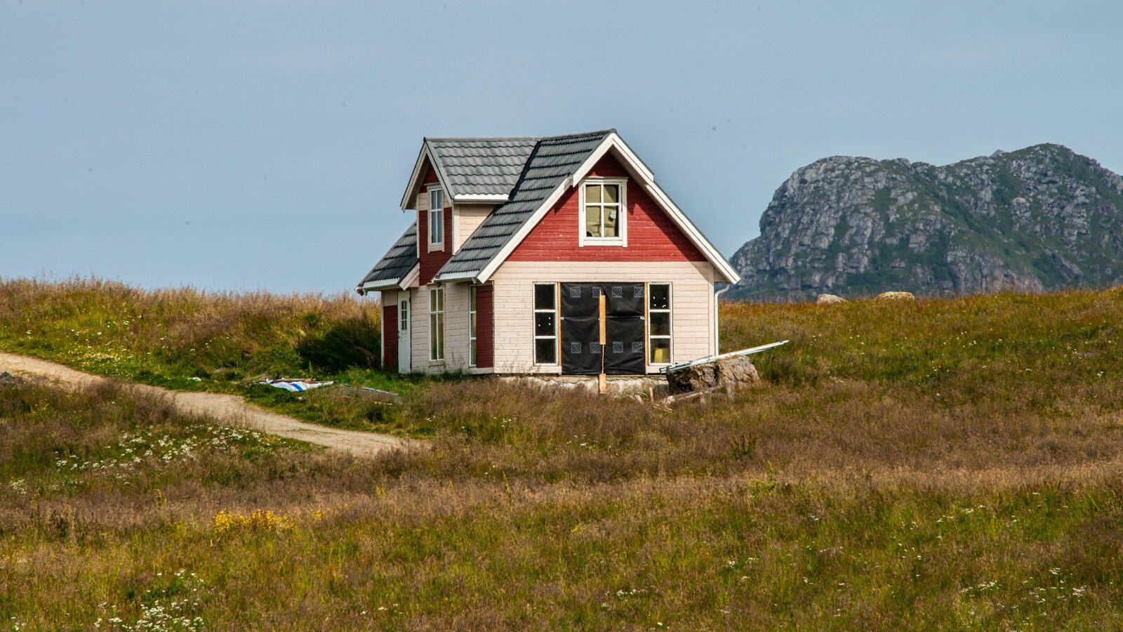 black and white house on green grass field